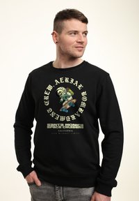 Felpa nera con stampa grafica audace che raffigura uno skateboarder scheletro. Il testo include "Santa Monica Space Cruisers" in bianco e verde.