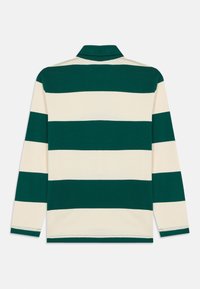 Striped long-sleeve polo shirt featuring a green and cream pattern. Soft cotton material with a collar and straight hem.