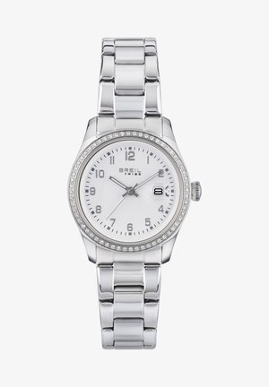 Montre en argent avec un boîtier rond et poli, un cadran blanc, des index d'heure argentés et un affichage de la date. Caractéristiques : lunette ornée de cristaux et bracelet en maillons métalliques.