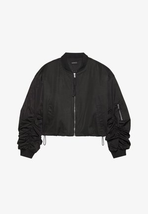 Melna bomber jakna ar īsu dizainu, kurai ir kroku piedurknes, ar rāvējslēdzējiem kabatas un ribota apkakle un aproces. Gluda, viegla auduma.
