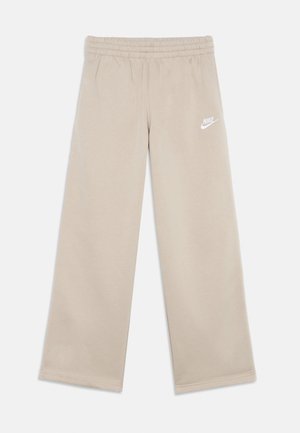 Pantaloni della tuta Nike beige, con vita elastica, gambe larghe e un piccolo logo bianco sul lato sinistro. Tessuto dalla texture liscia.