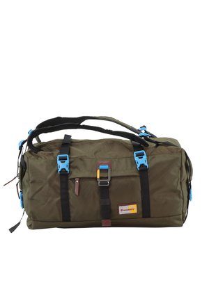 Olive green duffel bag with black straps, blue buckles, and a zipper pocket. Features a fabric texture and a colorful logo patch.
