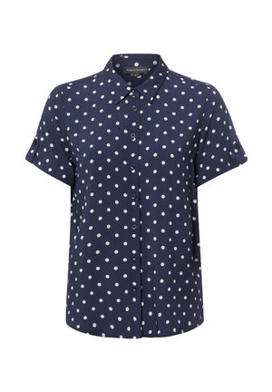 Marineblaue Kurzarmbluse mit weißen Polka-Dots und klassischem Kragen, mit Knopfdetails an hochgekrempelten Ärmeln.