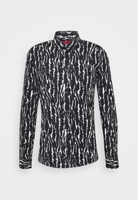 Camicia a righe bianco e nero con colletto, chiusura a bottoni, maniche lunghe e una texture di tessuto morbido.