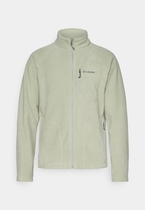 Jasnozielona polarowa kurtka z wysokim kołnierzem, przednim zamkiem błyskawicznym i dwoma bocznymi kieszeniami. Na lewej piersi znajduje się logo Columbia, a materiał jest gładki.