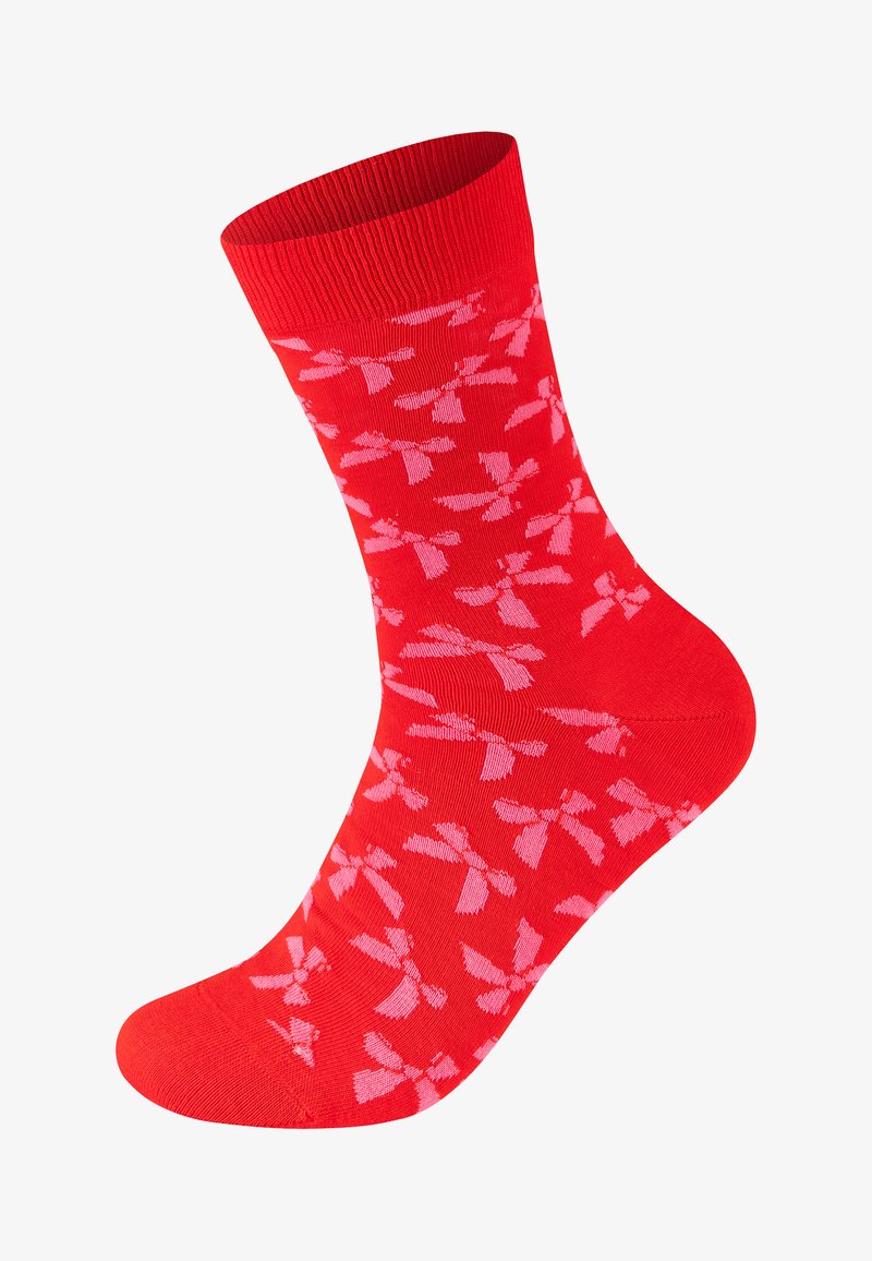 Chaussette rouge avec un motif de nœuds rose clair couvrant tout le tissu, avec un poignet côtelé en haut.
