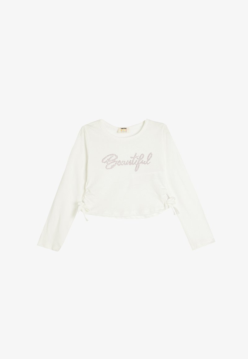 Biała, długorękawowa, krótka bluzka z ściągaczami po bokach, z napisem "Beautiful" ozdobionym metalicznymi ćwiekami. Wykonana z miękkiej bawełny.