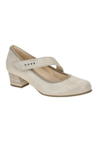 Beige suede Mary Jane shoe with a rounded toe, elastic strap, and decorative metal studs; low striped block heel adds stability.