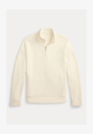 Kremfarget genser med lange ermer, kvartglidelås på kragen og subtil logo på venstre bryst, vist på en ensfarget hvit bakgrunn.