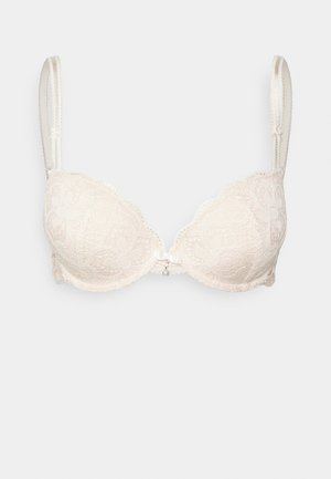Beiger Spitzen-BH mit gepolsterten Cups, gewellten Kanten, verstellbaren Trägern und einem kleinen Bogen mit einer Perlenakzent in der Mitte.
