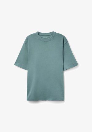 Korte mouwen t-shirt van zachte, turquoise katoen. Heeft een ronde halslijn en een ongepaste vorm met een relaxte pasvorm. Soepele textuur.