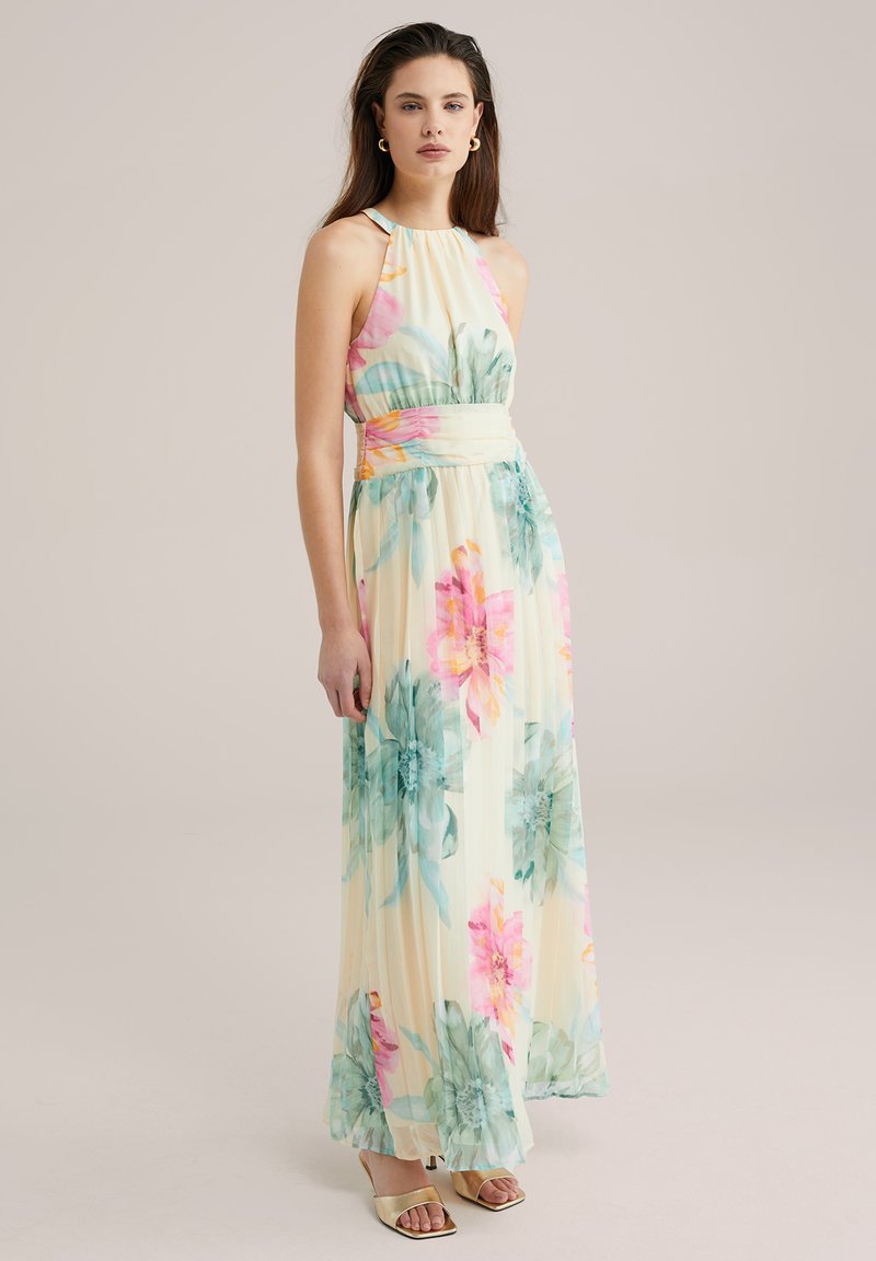 Maxi-mekko, joka on valmistettu kevyestä kankaan, jossa on kukkakuosi pastellivärissä vaaleanpunaisena, keltaisena ja vihreänä. Mekossa on naruolkaimet ja pleatattu muotoilu.