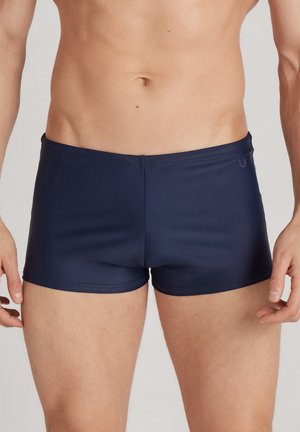 Dunkelblaue Schwimmshorts mit einem enganliegenden Design, aus glattem, dehnbarem Material gefertigt. Verfügt über einen schlichten Bund und ein minimalistisches Logodesign.
