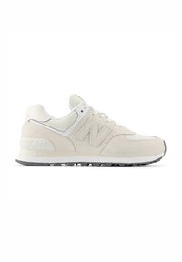 Men's New Balance sneakers in off-white suede and mesh, featuring a rounded toe, laced front, and a gray rubber outsole with a logo accent.