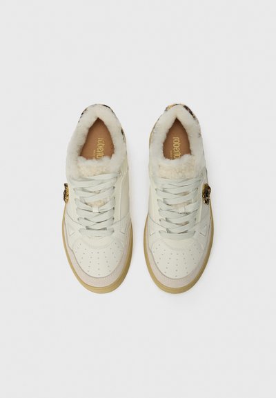 Pair of white lace-up sneakers with fluffy lining and leopard print detail on the heel, viewed from above on a white background.
