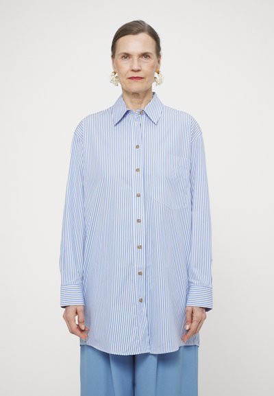 Blue and white striped shirt with a button-down front, a collar, and long sleeves. Features a chest pocket and gold buttons.