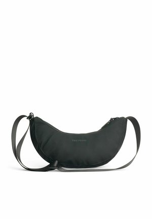 Black, curved shoulder bag made of durable material, featuring a zip closure and an adjustable strap with a nylon texture. Tretorn branding displayed.