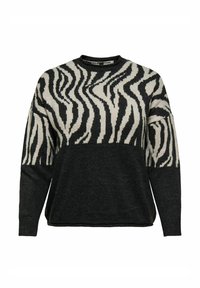Črn in krema pulover z zebra vzorcem na vrhu in enobarvnim črnim spodnjim delom. Narejen iz mehke pletene tkanine.