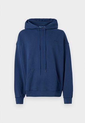 Navy zila kapuce no mīksta auduma, ar lielu kabatu, regulējamu aukliņu kapuci un ribotām piedurknēm un apakšmalu.