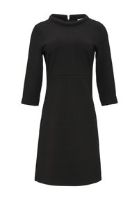 Robe noire avec un motif texturé, à manches longues et encolure bateau. Elle possède une fermeture éclair au dos et une silhouette en A longueur genoux.