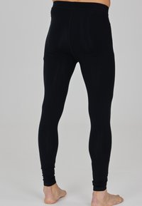 Schwarze Leggings mit einer glatten Textur, hohem Bund, figurbetontem Design und knöchellanger Schnittform.