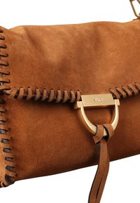 Brown suede handbag with a stitched edge, featuring a gold-tone hardware clasp and a decorative leather strap.