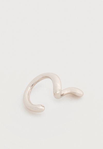 Λεία, κυρτή ασημένια δαχτυλίδι με ακανόνιστο, κυματιστό σχήμα, εμφανίζεται σε απλό ανοιχτό φόντο.