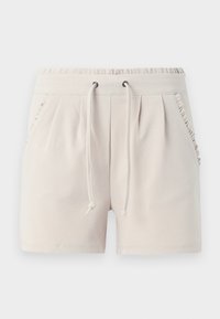 Pantalones cortos color beige claro hechos de una tela suave, con una cinturilla elástica con cordón y bordes de los bolsillos laterales con volantes.