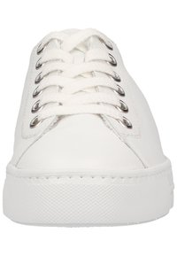 Baskets en toile blanches avec un bout rond, une tige texturée, et six œillets pour les lacets. Semelle en caoutchouc avec des détails de couture autour du bord.