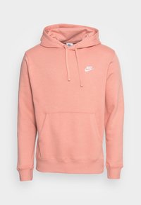 Pink Nike pullover hoodie with a front kangaroo pocket, adjustable drawstring hood, and white logo accent on the chest. Soft fabric texture.