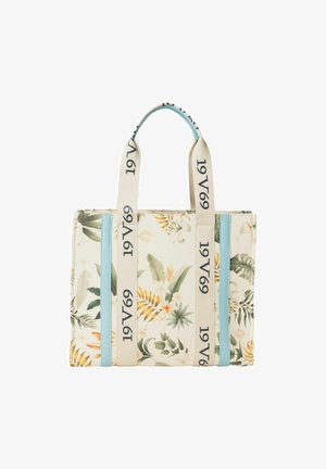 Bloemenprint draagtas van crème stof met blauwe accenten en beige handvatten met tekst. Vierkante vorm met twee handgrepen aan de bovenkant.