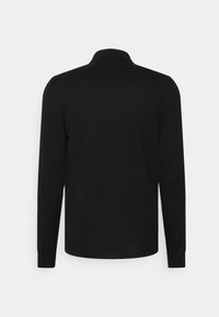 Pull noir à manches longues avec col montant, présenté de dos sur un fond blanc uni.