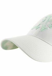 White baseball cap with light green embroidered text on front and curved brim.