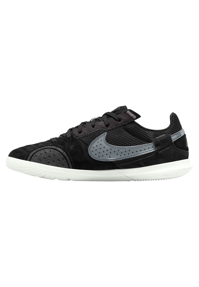 Black sneaker with a mix of suede and mesh upper, featuring grey accents, perforated details, and a white rubber sole.