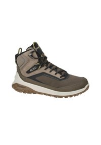 Scarpa da trekking impermeabile marrone con tomaia in mesh testurizzato, dettagli neri e suola in gomma. Caratterizzata da un lacci sicuri e un collare imbottito.