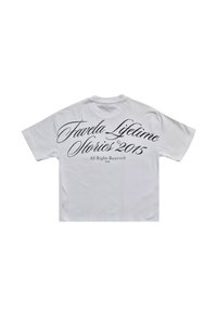 White cotton t-shirt with short sleeves, featuring black cursive text on the back: "Favela Lifetime Stories 2015" and copyright details.