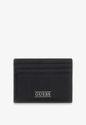 Porte-cartes Guess noir avec texture perforée et quatre emplacements pour cartes, arborant un logo Guess argenté sur le devant.