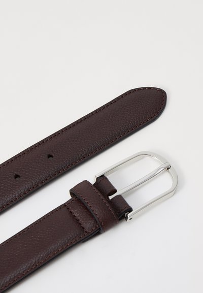 Brown leather belt with textured surface, silver metal buckle, and five holes for adjustment. Ends are tapered and stitched.