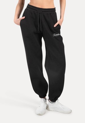 Pantalones de chándal negros con cintura elástica, bolsillos laterales, tobillos ajustados y logo bordado en la parte delantera. Fabricados con un tejido suave y duradero.