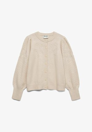 Bežinė megzta mygtukinė kardiganas su gėlių siuvinėjimu ant krūtinės ir pūstomis, raštuotomis ilgomis rankovėmis su raukiniais ant rankovių ir hemu.