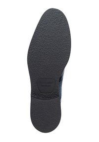 Suola di scarpa in gomma nera con superficie testurizzata, caratterizzata da un motivo intrecciato blu sopra e un logo su una toppa rettangolare al tallone.