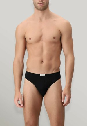 Slip da uomo nero con design a vita bassa, tessuto morbido e una piccola etichetta in vita. Presenta copertura minimale e un taglio base.