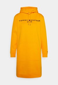 Gelbes Kapuzensweatkleid aus Baumwollmischung. Verfügt über eine Fronttasche und das Logo "TOMMY HILFIGER" in Schwarz. Gerippte Bündchen mit Logodetail.