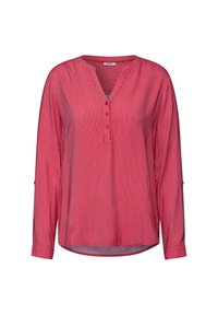 Maglietta a maniche lunghe a righe rosse e bianche con una chiusura a bottoni, scollatura rotonda e maniche arrotolate. Realizzata in tessuto leggero.