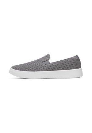 Sneaker slip-on grigia con tomaia in tessuto strutturato e suola spessa in gomma bianca, vista di lato su sfondo bianco.