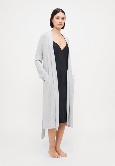 Gray long cardigan made of soft material, featuring an open front, two side pockets, and ribbed accents on sleeves and hem.