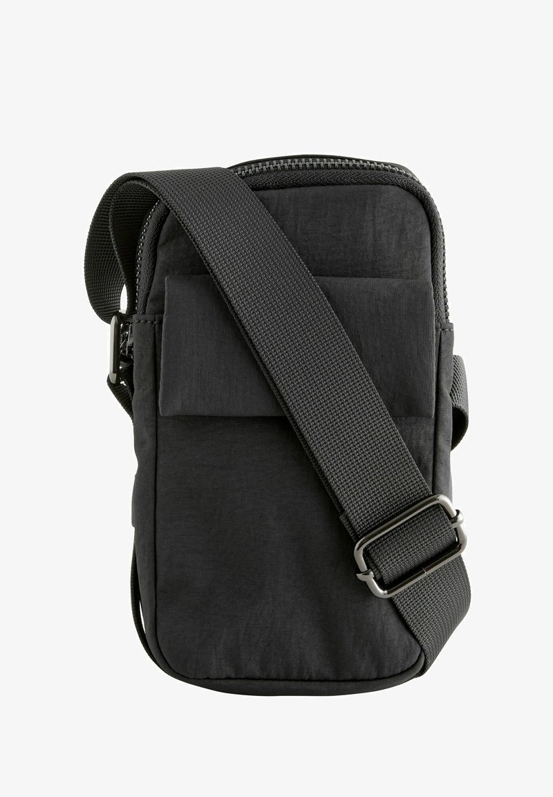 Must musta rihmavöö, millel on lukuga ülemine osa, lame esikott ja reguleeritav rihm. Sile tekstuur ja ristkülikukujuline kuju.