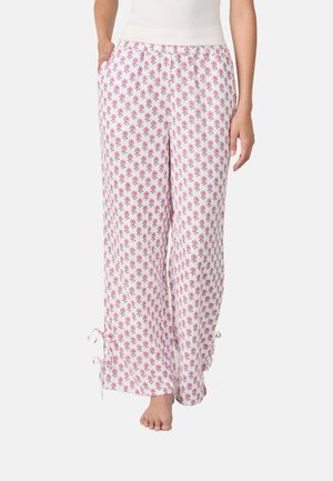 Pantalons de pyjama à motif floral en blanc et rose, fabriqués à partir d'un tissu doux, avec une taille élastique et des liens ajustables à l'ourlet.