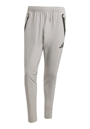 Pantalons de sport gris clair avec une taille élastique, deux poches latérales avec des zips noirs et un logo noir sur la jambe gauche.