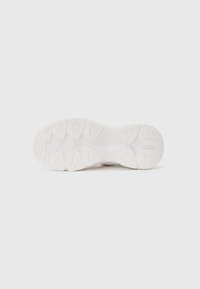 White sneaker sole with textured rubber pattern featuring grooves and traction points, designed for grip and durability.